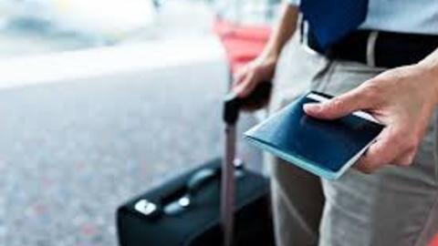 luggage and passport in traveler's hands