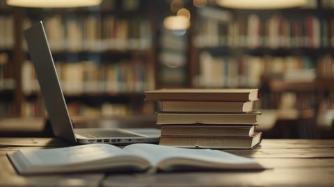 books next to a laptop