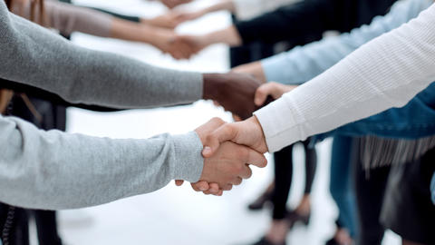 diverse people shaking hands