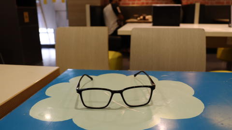 eyeglasses laying on top of salesforce logo on desk