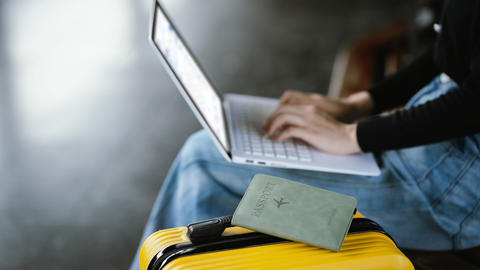 suitcase passport and laptop