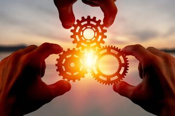 hands holding circular gears